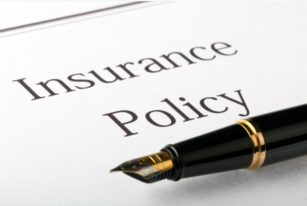 Insurance policy document and pen